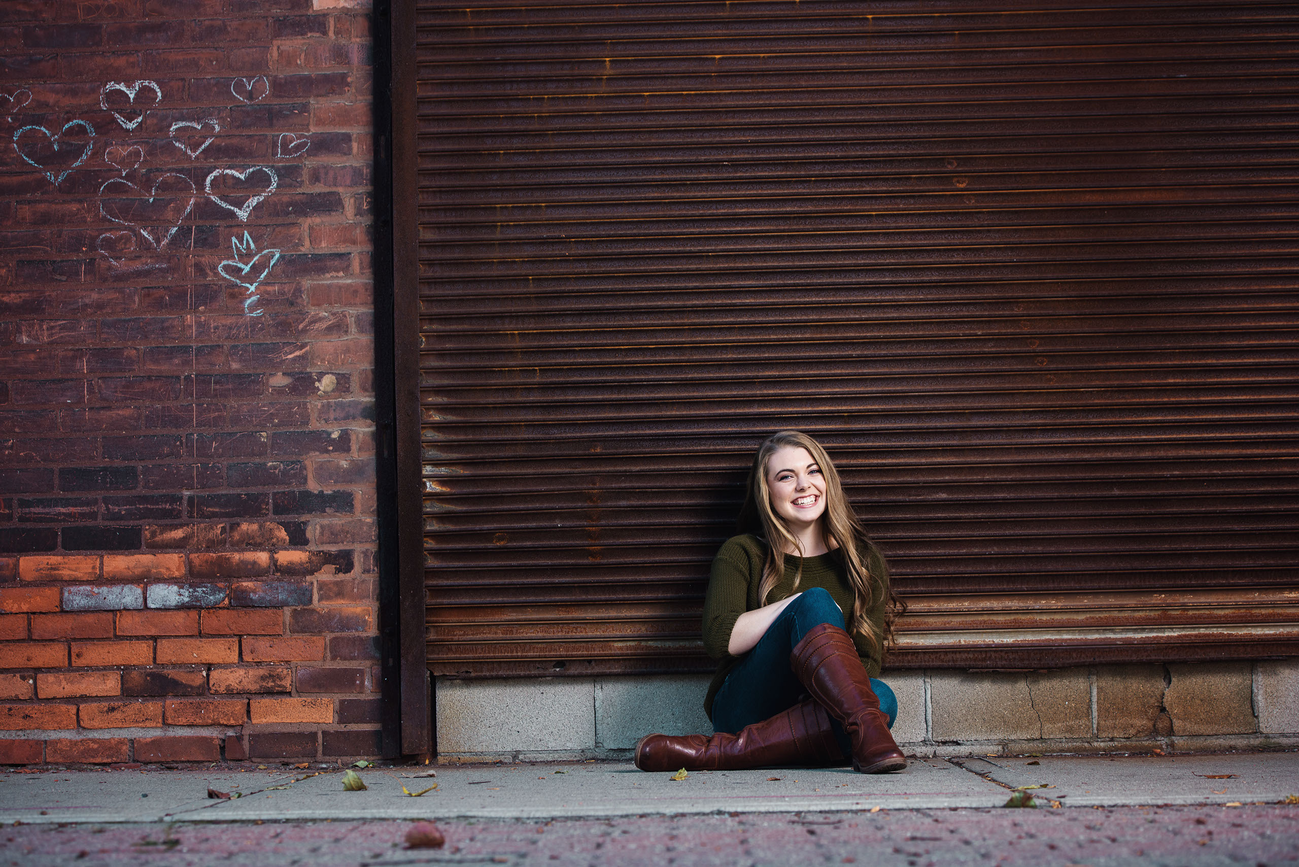 A Senior photo of Anthony Wayne High School student, Kelsey, posing with an Elephant at the Toledo Lucas County Fair.